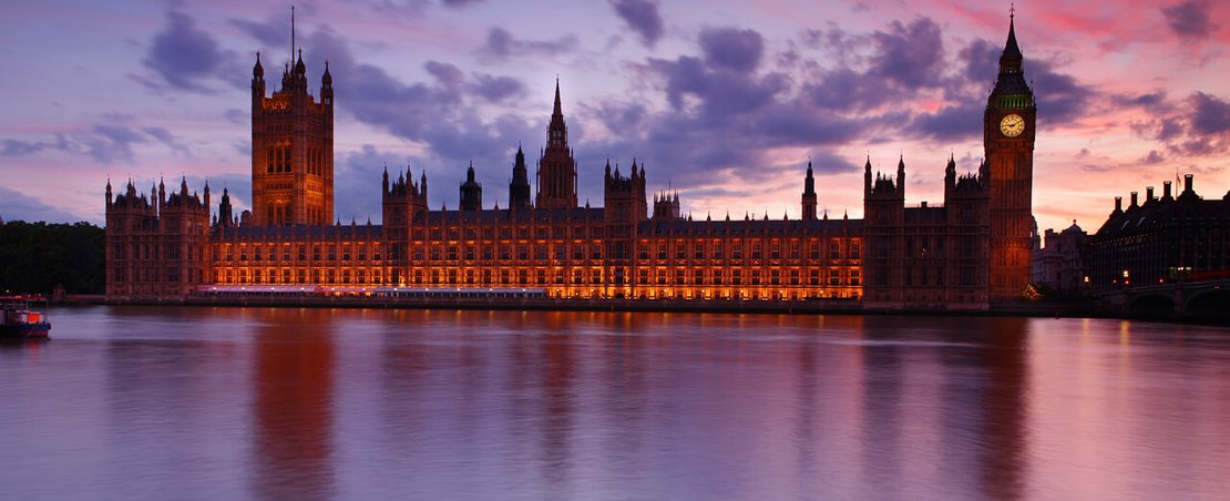 The Big Ben clock tower illuminated by the warm hues of sunset, creating a stunning silhouette against the evening sky.