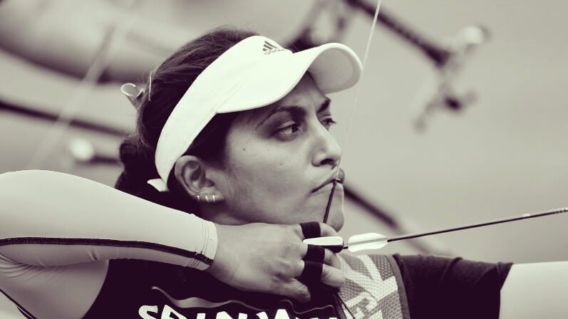 Close up of Tania Nadarajah aiming bow and arrow