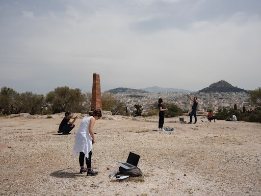 photo of people recording weather via laptop in a desert