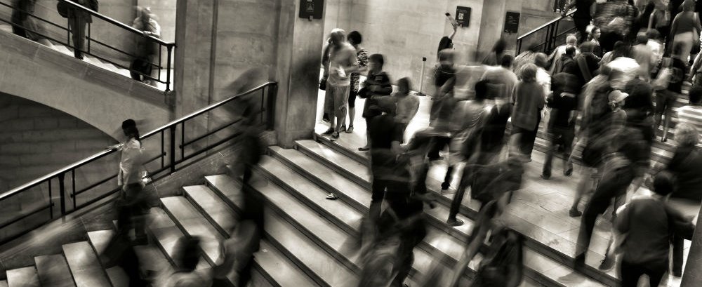 People on stairs in gallery