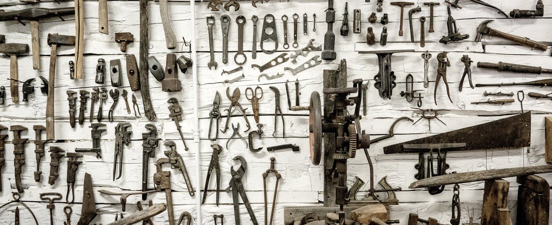 Tools hanging on toolshed wall