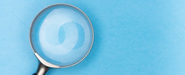 Magnifying glass against blue background